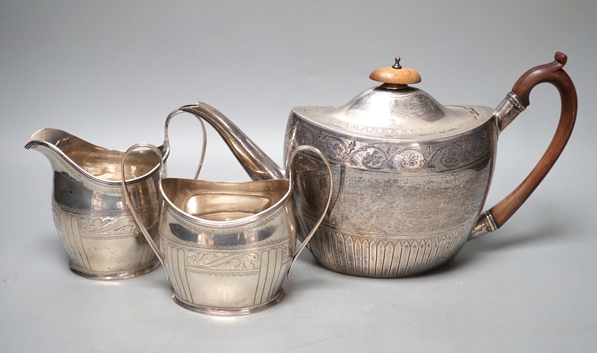 A 1930's engraved silver oval three piece tea set, S. Blanckensee & Sons Ltd, Chester, 1936/7, gross weight 26.5oz.